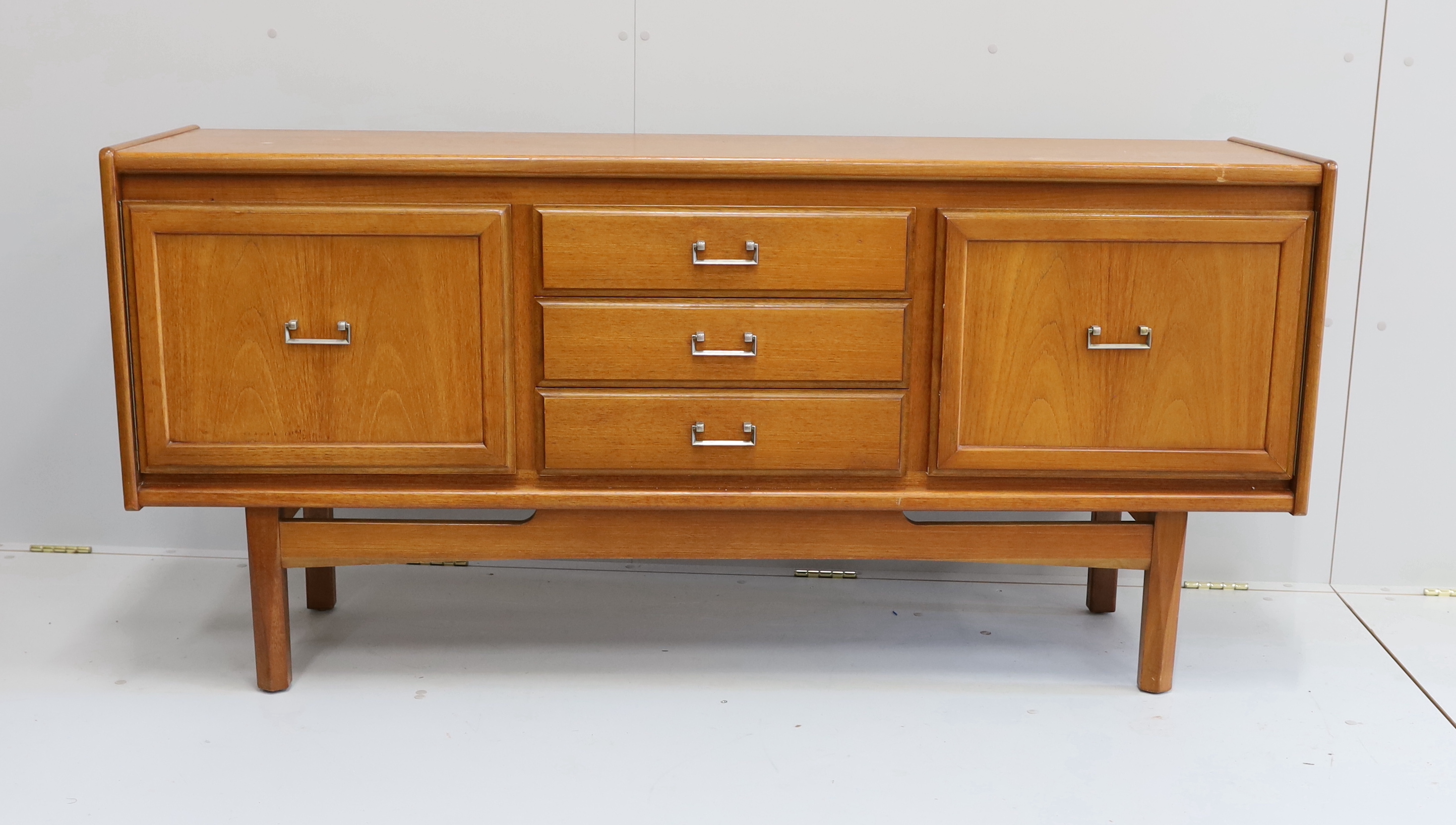 A mid century teak sideboard, bears William Lawrence label, width 163cm, depth 44cm, height 77cm